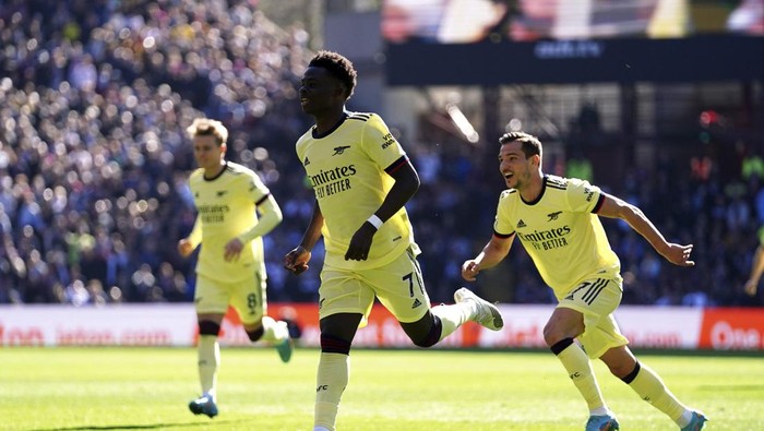 Arsenals Bukayo Saka celebrates scoring the opening goal during the English Premier League soccer match between Aston Villa and Arsenal at Villa Park, Birmingham, England, Saturday, March 19, 2022. (Nick Potts/PA via AP)