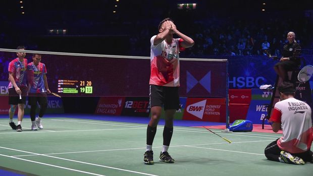 Indonesia's Muhammad Shohibul Fikri, center, and Bagas Maulana, right, celebrate after defeating their compatriots Mohammad Ahsan and Hendra Setiawan during their men's doubles final match at the All England Open Badminton Championships in Birmingham, England, Sunday, March 20, 2022. (AP Photo/Rui Vieira)