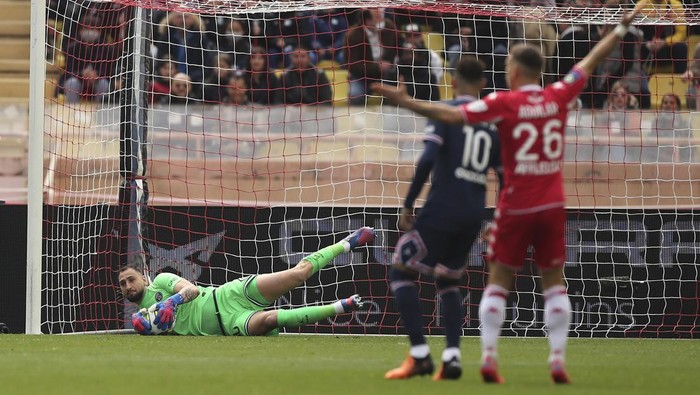 PSGs goalkeeper Gianluigi Donnarumma saves a shot during the French League One soccer match between Monaco and Paris Saint-Germain at the Stade Louis II in Monaco, Sunday, March 20, 2022. (AP Photo/Daniel Cole)