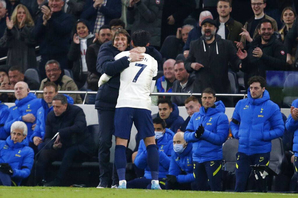 Tottenham's Son Heung-min celebrates with his coach Antonio Conte after scoring his side's third goal during the English Premier League soccer match between Tottenham Hotspur and West Ham United at Tottenham Hotspur Stadium, in London, Sunday, March 20, 2022. (AP Photo/David Cliff)