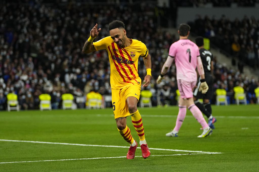Barcelona's Pierre-Emerick Aubameyang celebrates after scoring his side's fourth goal during a Spanish La Liga soccer match between Rial Madrid and FC Barcelona at the Santiago Bernabeu stadium in Madrid, Spain, Sunday, March 20, 2022. (AP Photo/Manu Fernandez)