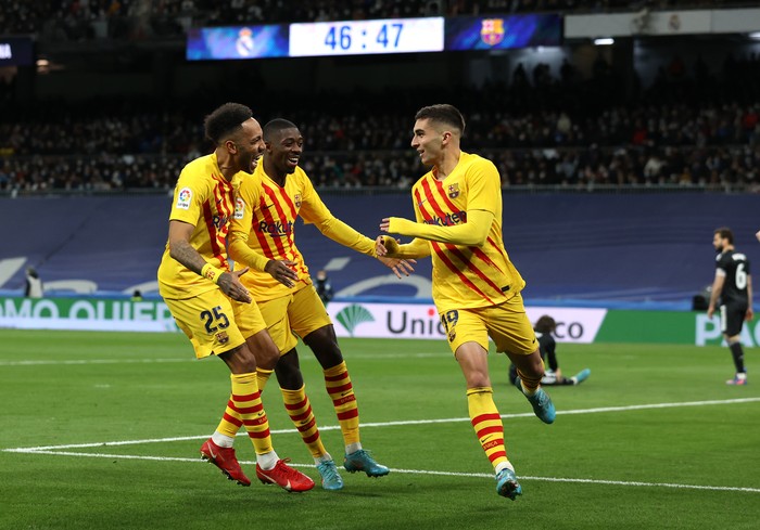 LaLiga MADRID, SPAIN - MARCH 20: Ferran Torres of Barcelona celebrates with Pierre-Emerick Aubameyang and Ousmane Dembele after scoring their team's third goal during the LaLiga Santander match between Real Madrid CF and FC Barcelona at Estadio Santiago Bernabeu on March 20, 2022 in Madrid, Spain. (Photo by Gonzalo Arroyo Moreno/Getty Images)