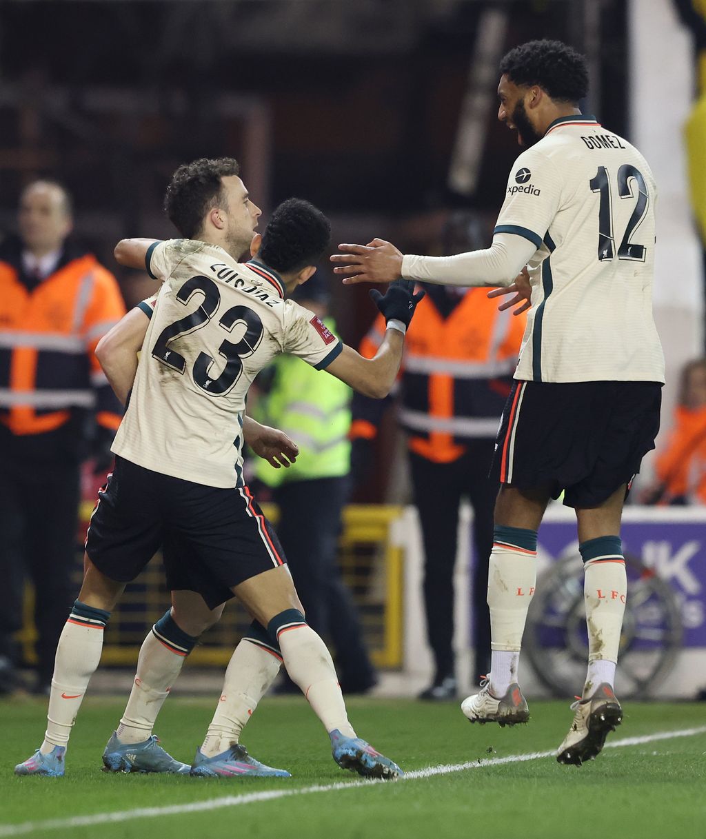 NOTTINGHAM, ENGLAND - MARCH 20: Diogo Jota of Liverpool celebrates after scoring their side's first goal with Luis Diaz and Joe Gomez during the Emirates FA Cup Quarter Final match between Nottingham Forest and Liverpool at City Ground on March 20, 2022 in Nottingham, England. (Photo by Matthew Lewis/Getty Images)
