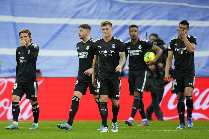 Real Madrid players walk in dejection after Barcelonas Ronald Araujo scores his sides second goal during a Spanish La Liga soccer match between Rial Madrid and FC Barcelona at the Santiago Bernabeu stadium in Madrid, Spain, Sunday, March 20, 2022. (AP Photo/Manu Fernandez)