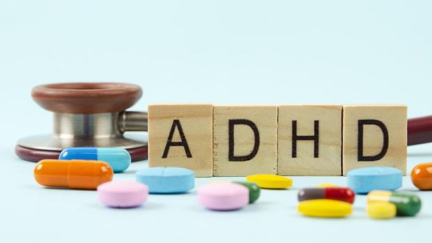 Attention deficit hyperactivity disorder or ADHD with stethoscope and medication.