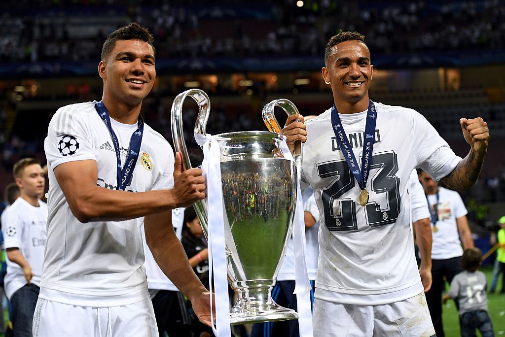 MILAN, ITALY - MAY 28: Casemiro (L) and Danilo of Real Madrid pose with the trophy after winning the UEFA Champions League Final match between Real Madrid and Club Atletico de Madrid at Stadio Giuseppe Meazza on May 28, 2016 in Milan, Italy.  (Photo by Matthias Hangst/Getty Images)