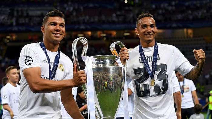 MILAN, ITALY - MAY 28: Casemiro (L) and Danilo of Real Madrid pose with the trophy after winning the UEFA Champions League Final match between Real Madrid and Club Atletico de Madrid at Stadio Giuseppe Meazza on May 28, 2016 in Milan, Italy.  (Photo by Matthias Hangst/Getty Images)