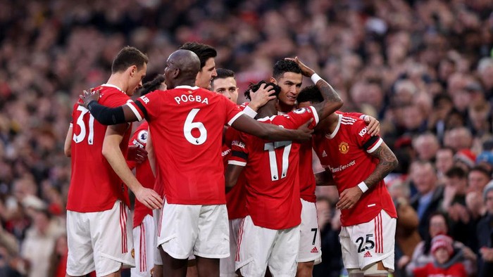 MANCHESTER, ENGLAND - MARCH 12: Cristiano Ronaldo of Manchester United celebrates with his team after scoring their teams first goal during the Premier League match between Manchester United and Tottenham Hotspur at Old Trafford on March 12, 2022 in Manchester, England. (Photo by Naomi Baker/Getty Images)