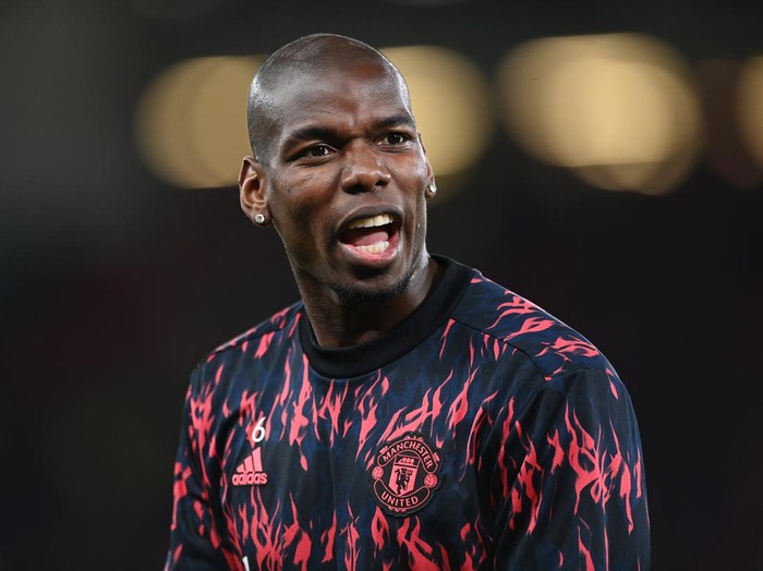 MANCHESTER, ENGLAND - MARCH 15: Paul Pogba of Manchester United warms up prior to the UEFA Champions League Round Of Sixteen Leg Two match between Manchester United and Atletico Madrid at Old Trafford on March 15, 2022 in Manchester, England. (Photo by Michael Regan/Getty Images)