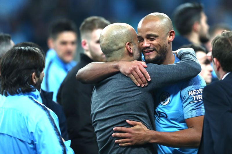 LONDON, ENGLAND - FEBRUARY 24:  Vincent Kompany of Manchester City is congratulated by Josep Guardiola, Manager of Manchester City following the Carabao Cup Final between Chelsea and Manchester City at Wembley Stadium on February 24, 2019 in London, England.  (Photo by Clive Rose/Getty Images)