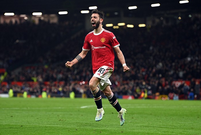 MANCHESTER, ENGLAND - FEBRUARY 15: Bruno Fernandes of Manchester United celebrates after scoring their teams second goal during the Premier League match between Manchester United and Brighton & Hove Albion at Old Trafford on February 15, 2022 in Manchester, England. (Photo by Gareth Copley/Getty Images)