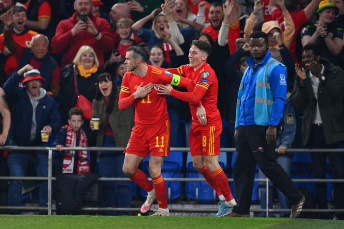 CARDIFF, WALES - MARCH 24: Gareth Bale of Wales (L) celebrates with teammate Harry Wilson after scoring their teams second goal during the 2022 FIFA World Cup Qualifier knockout round play-off match between Wales and Austria at Cardiff City Stadium on March 24, 2022 in Cardiff, Wales. (Photo by Dan Mullan/Getty Images)