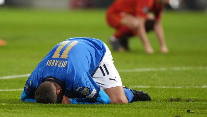 North Macedonia players celebrate as Italys Alessandro Bastoni reacts after his teams got eliminated at the end of the World Cup qualifying play-off soccer match between Italy and North Macedonia, at Renzo Barbera stadium, in Palermo, Italy, Thursday, March 24, 2022. North Macedonia won 1-0. (AP Photo/Antonio Calanni)