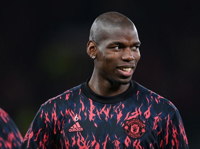 MANCHESTER, ENGLAND - MARCH 15: Paul Pogba of Manchester United warms up prior to the UEFA Champions League Round Of Sixteen Leg Two match between Manchester United and Atletico Madrid at Old Trafford on March 15, 2022 in Manchester, England. (Photo by Michael Regan/Getty Images)
