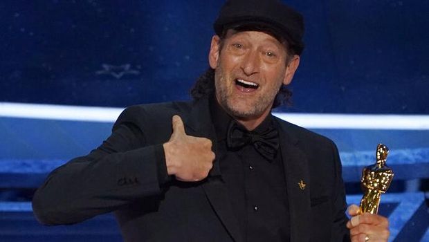 Troy Kotsur accepts the award for best performance by an actor in a supporting role for 