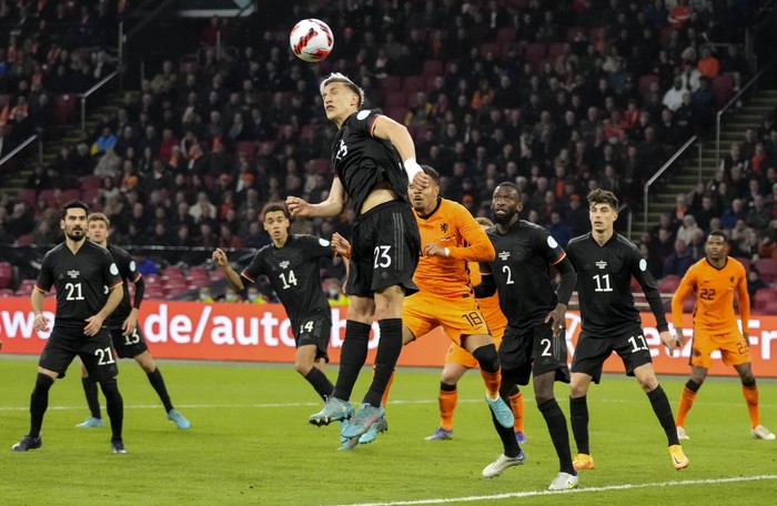 Germanys Nico Schlotterbeck, center, clears the ball during the international friendly soccer match between the Netherlands and Germany at the Johan Cruyff ArenA in Amsterdam, Netherlands, Tuesday, March 29, 2022. (AP Photo/Peter Dejong)