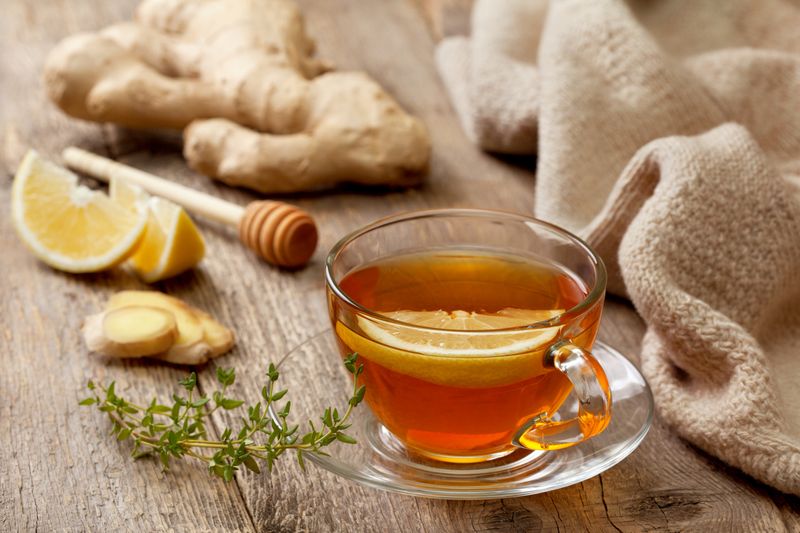 ilustrasi teh jahe untuk diet tea with ginger, lemon and thyme on old wooden background