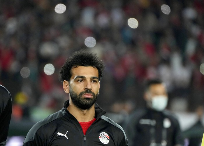 Egypts Mohamed Salah listens to the national anthem during a qualifying soccer match against Senegal for the FIFA World Cup Qatar 2022 at Cairo International stadium in Cairo, Egypt, Friday, March 25, 2022. (AP Photo/Amr Nabil)