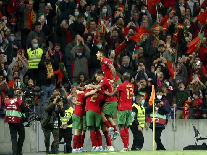 Portugal players celebrate after scoring the opening goal during the World Cup 2022 playoff soccer match between Portugal and North Macedonia, at the Dragao stadium in Porto, Portugal, Tuesday, March 29, 2022. (AP Photo/Luis Vieira)
