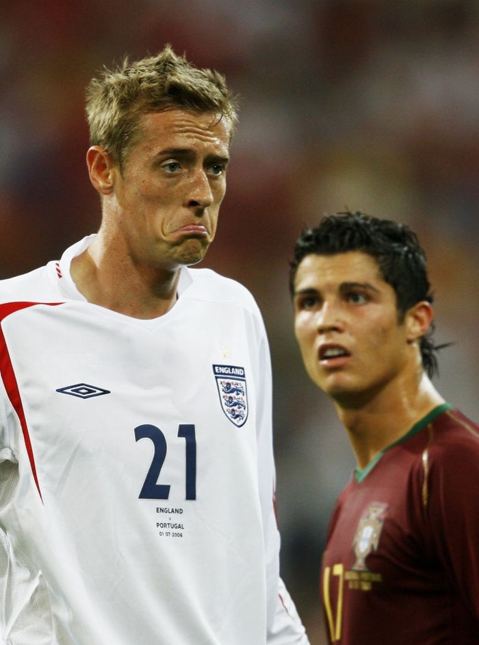 GELSENKIRCHEN, GERMANY - JULY 01: Peter Crouch of England pulls a face as Cristiano Ronaldo of Portugal looks on during the FIFA World Cup Germany 2006 Quarter-final match between England and Portugal played at the Stadium Gelsenkirchen on July 1, 2006 in Gelsenkirchen, Germany. (Photo by Shaun Botterill/Getty Images)