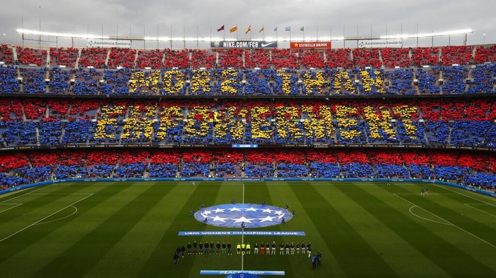 Supporters hold up banners reading 