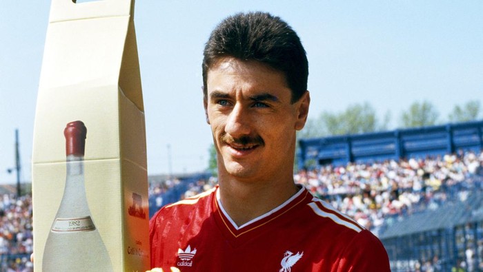 ian rush liverpool LONDON, UNITED KINGDOM - MAY 09: Liverpool striker poses with his 'leaving presents' from Chelsea of a large bottle of Frascati, and a bunch of celery before his last match against Chelsea at Stamford Bridge on May 9, 1987 before transferring to Juventus in Italy, (Photo by Dan Smith/Allsport/Getty Images)