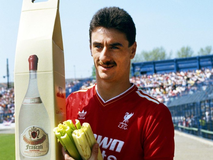 LONDON, UNITED KINGDOM - MAY 09:  Liverpool striker poses with his 'leaving presents' from Chelsea of a large bottle of Frascati, and a bunch of celery  before his last match against Chelsea at Stamford Bridge on May 9, 1987 before transferring to Juventus in Italy,   (Photo by Dan Smith/Allsport/Getty Images)