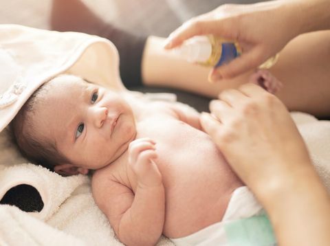 Mother makes massage with baby oil