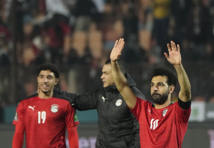 Egypts Mohamed Salah, right, with teammates greets fans after winning a qualifying soccer match 1-0 against Senegal for the FIFA World Cup Qatar 2022 at Cairo International stadium in Cairo, Egypt, Friday, March 25, 2022. (AP Photo/Amr Nabil)