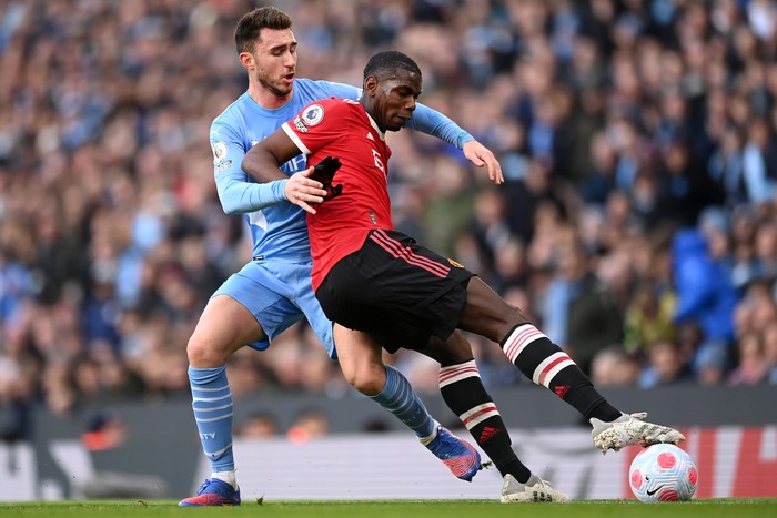 MANCHESTER, ENGLAND - MARCH 06: Paul Pogba of Manchester United battles for possession with Aymeric Laporte of Manchester City during the Premier League match between Manchester City and Manchester United at Etihad Stadium on March 06, 2022 in Manchester, England. (Photo by Michael Regan/Getty Images)