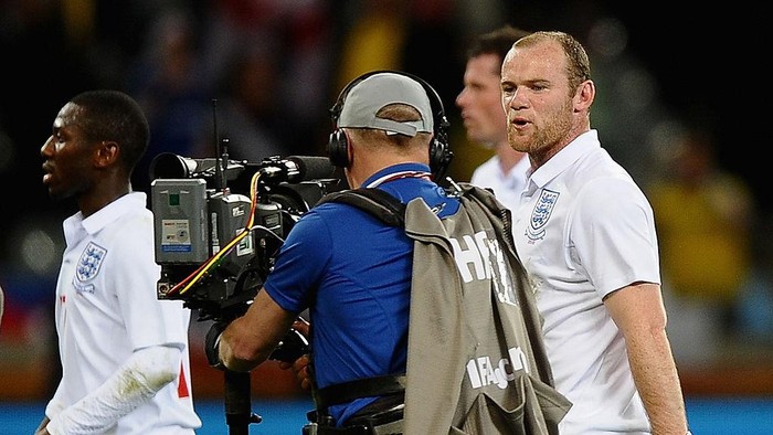 CAPE TOWN, SOUTH AFRICA - JUNE 18: Wayne Rooney of England speaks to a cameraman as he walks off the pitch dejected after the 2010 FIFA World Cup South Africa Group C match between England and Algeria at Green Point Stadium on June 18, 2010 in Cape Town, South Africa.  (Photo by Laurence Griffiths/Getty Images)