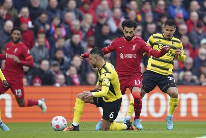 Liverpools Mohamed Salah, center, challenges for the ball with Watfords Cucho Hernandez, right, and Watfords Imran Louza during the English Premier League soccer match between Liverpool and Watford at Anfield stadium in Liverpool, England, Saturday, April 2, 2022. (AP Photo/Jon Super)