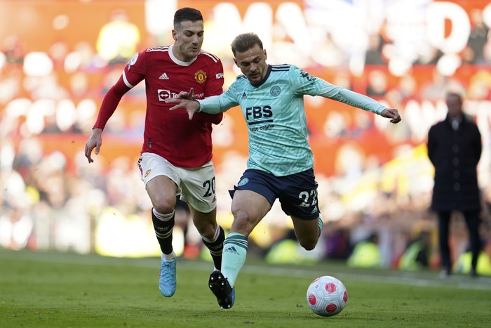 Manchester Uniteds Diogo Dalot vies for the ball with Leicesters Kiernan Dewsbury-Hall, right, during the English Premier League soccer match between Manchester United and Leicester City at Old Trafford in Manchester, England, Saturday, April 2, 2022. (AP Photo/Jon Super)