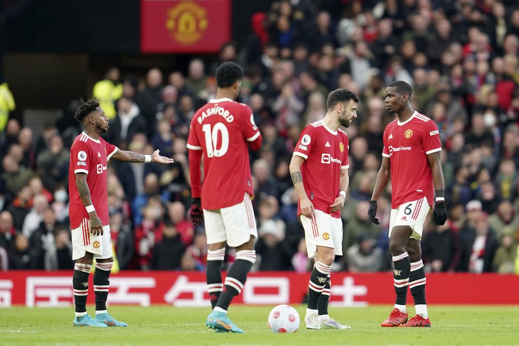 Manchester United's Fred, Marcus Rashford, Bruno Fernandes and Paul Pogba, from left, react after Leicester scored the opening goal during the English Premier League soccer match between Manchester United and Leicester City at Old Trafford in Manchester, England, Saturday, April 2, 2022. (AP Photo/Jon Super)