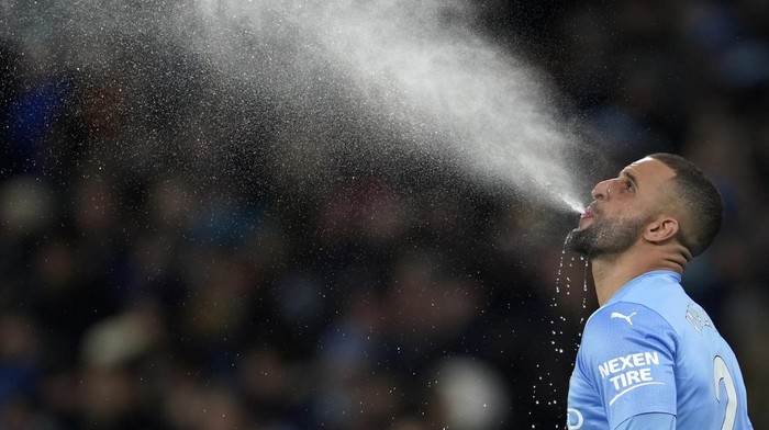 Manchester Citys Kyle Walker spitting water ahead of second half of the English Premier League soccer match between Manchester City and Tottenham Hotspur, at the Etihad stadium in Manchester, England, Saturday, Feb. 19, 2022. (AP Photo/Jon Super)