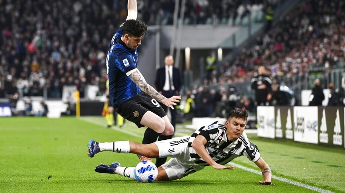 Inters Alessandro Bastoni, left, and Juventus Paulo Dybala vie for the ball during the Serie A soccer match between Juventus and Inter Milan, at the Allianz stadium in Turin, Italy, Sunday, April 3, 2022. (Fabio Ferrari/LaPresse via AP)