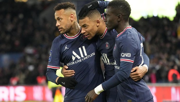 PSGs Kylian Mbappe, center, celebrates with his teammates Idrissa Gueye, right, and Neymar after scoring his sides second goal during the French League One soccer match between Paris Saint Germain and FC Lorient at Parc des Princes stadium in Paris, Sunday, April 3, 2022. (AP Photo/Michel Euler)