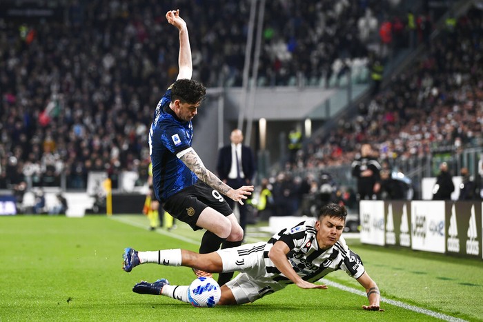 Inters Alessandro Bastoni, left, and Juventus Paulo Dybala vie for the ball during the Serie A soccer match between Juventus and Inter Milan, at the Allianz stadium in Turin, Italy, Sunday, April 3, 2022. (Fabio Ferrari/LaPresse via AP)