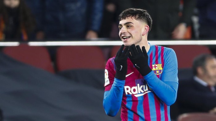 Barcelonas Pedri celebrates after scoring the opening goal during the Spanish La Liga soccer match between FC Barcelona and Sevilla at the Camp Nou stadium in Barcelona, Spain, Sunday, April 3, 2022. (AP Photo/Joan Monfort)