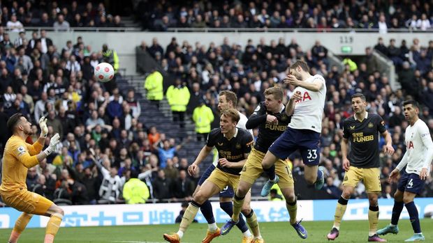 Newcastle's Fabian Schaer, left, scores the opening goal of his team during the Premier League soccer match between Tottenham Hotspur and Newcastle at Tottenham Hotspur stadium, in London, England, Sunday, April 3, 2022. (AP Photo/Ian Walton)