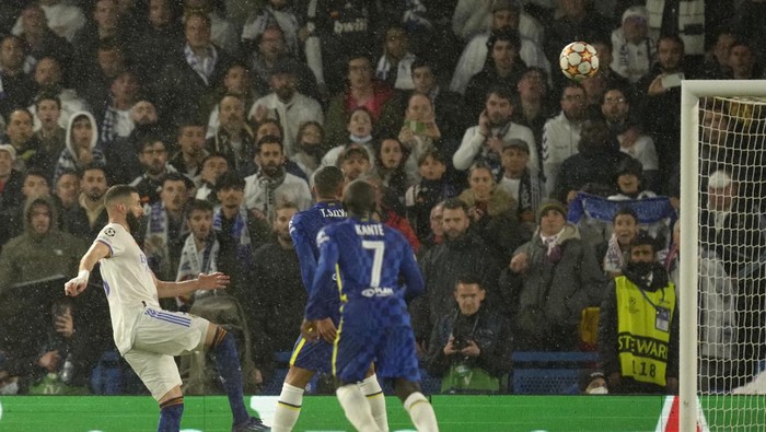 Real Madrids Karim Benzema, left, heads the ball to score his sides second goal during a Champions League first-leg quarterfinal soccer match between Chelsea and Real Madrid at Stamford Bridge stadium in London, Wednesday, April 6, 2022. (AP Photo/Kirsty Wigglesworth)