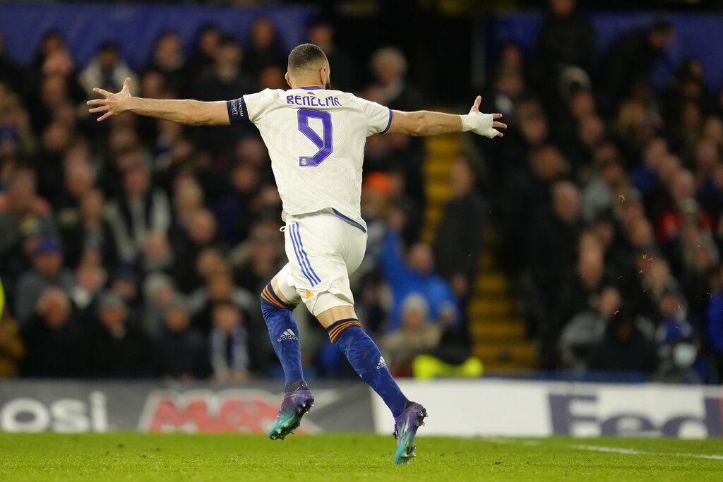 Real Madrid's Karim Benzema celebrates after scoring his side's third goal during a Champions League first-leg quarterfinal soccer match between Chelsea and Real Madrid at Stamford Bridge stadium in London, Wednesday, April 6, 2022. (AP Photo/Kirsty Wigglesworth)