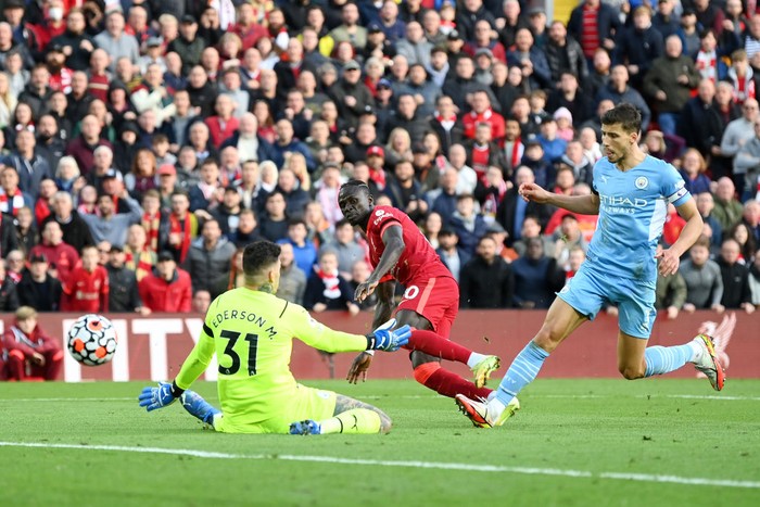 LIVERPOOL, ENGLAND - OCTOBER 03: Sadio Mane of Liverpool scores his sides first goal past Ederson of Manchester City during the Premier League match between Liverpool and Manchester City at Anfield on October 03, 2021 in Liverpool, England. (Photo by Michael Regan/Getty Images)