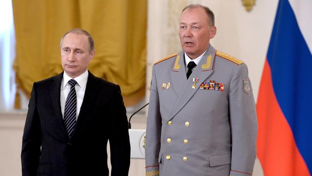 In this pool photo taken on Thursday, March  17, 2016, Russian President Vladimir Putin, left, poses with Col. Gen. Alexander Dvornikov during an awarding ceremony in Moscow's Kremlin, Russia . Dvornikov, who commanded the Russian military in Syria, said in an interview released Wednesday that Russias special forces have helped direct air raids in Syria and Russian military advisers have played a key role in the Syrian armys offensive.(Alexei Nikolsky/Sputnik, Kremlin Pool Photo via AP)