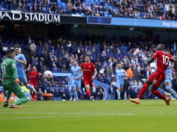 Manchester City's Kevin De Bruyne, centre, celebrates after scoring the opening goal of the game during the English Premier League soccer match between Manchester City and Liverpool, in Manchester, England, Sunday, April 10, 2022. (AP Photo/Jon Super)
