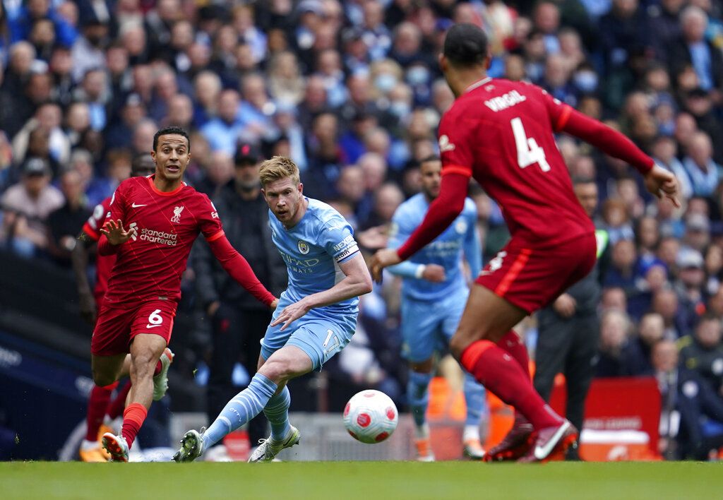 Manchester City's Kevin De Bruyne, centre, celebrates after scoring the opening goal of the game during the English Premier League soccer match between Manchester City and Liverpool, in Manchester, England, Sunday, April 10, 2022. (AP Photo/Jon Super)