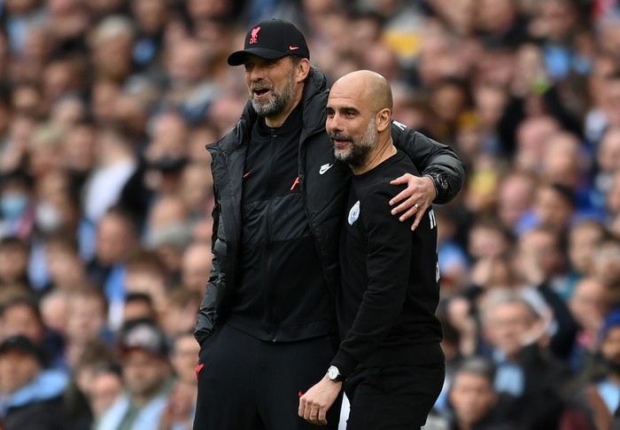 MANCHESTER, ENGLAND - APRIL 10: Pep Guardiola, Manager of Manchester City interacts with Jurgen Klopp, Manager of Liverpool during the Premier League match between Manchester City and Liverpool at Etihad Stadium on April 10, 2022 in Manchester, England. (Photo by Michael Regan/Getty Images)