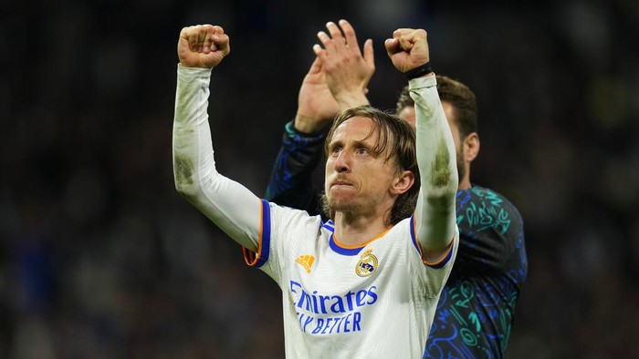 Real Madrids Luka Modric celebrates after his team qualified for the semifinals, at the end of the Champions League, quarterfinal second leg soccer match between Real Madrid and Chelsea at the Santiago Bernabeu stadium in Madrid, Spain, Tuesday, April 12, 2022. (AP Photo/Manu Fernandez)