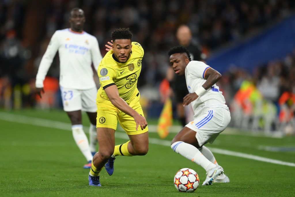MADRID, SPAIN - APRIL 12: Reece James of Chelsea runs with the ball from Vinicius Junior of Real Madrid during the UEFA Champions League Quarter Final Leg Two match between Real Madrid and Chelsea FC at Estadio Santiago Bernabeu on April 12, 2022 in Madrid, Spain. (Photo by David Ramos/Getty Images)