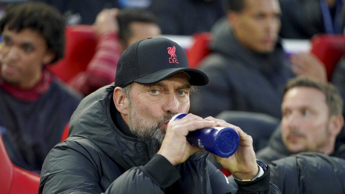 Liverpools manager Jurgen Klopp sips from a bottle before the Champions League quarterfinal second leg soccer match between Liverpool and Benfica, at Anfield stadium in Liverpool, England, Wednesday, April 13, 2022. (AP Photo/Jon Super)